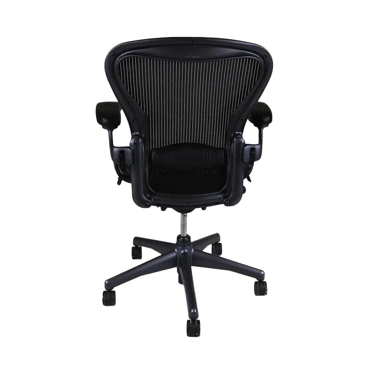 The Herman Miller Aeron, Size B, Full house has been refurbished to near factory standards. A mesh chair with every adjustment you would ever require to provide the perfect ergonomic experience. Adjustable arms, Adjustable height and Lumber and in Graphite. This is a Back view.